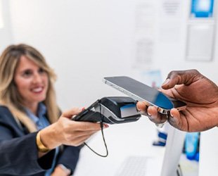 Dental team member accepting payment from patient