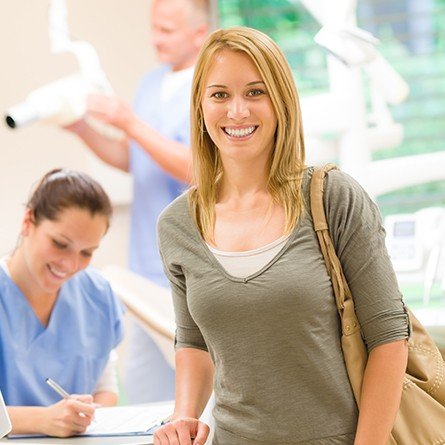 woman smiling by front desk