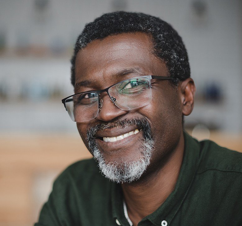 man with glasses smiling at camera