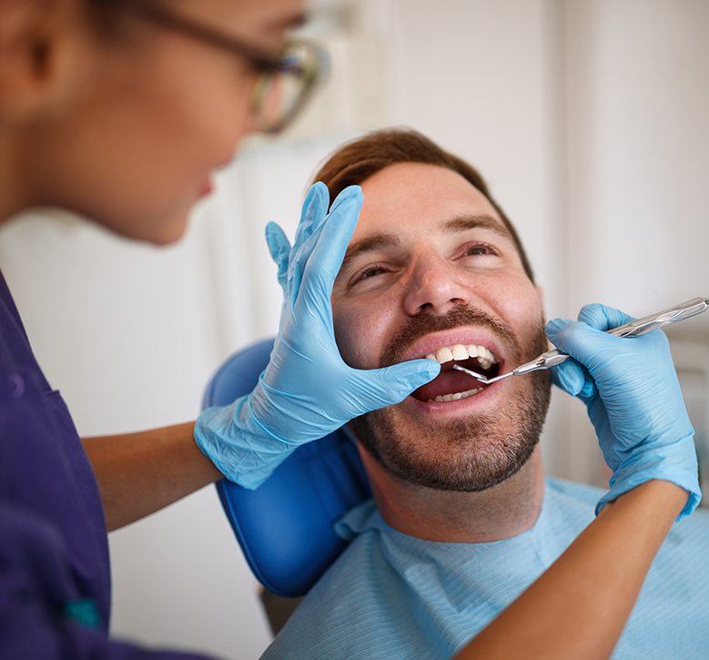 man having teeth checked