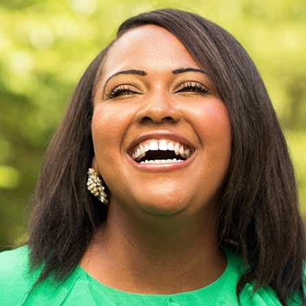 woman in green laughing