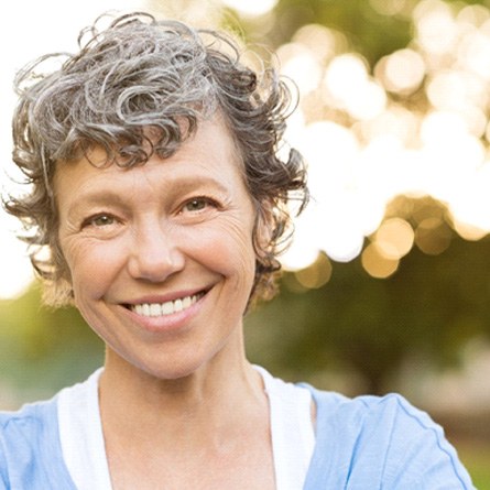 woman smiling while standing outside