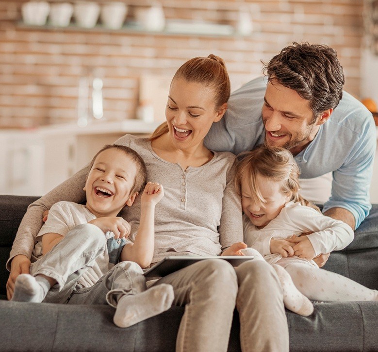 family laughing on couch