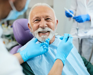 a patient smiling while getting his teeth checked