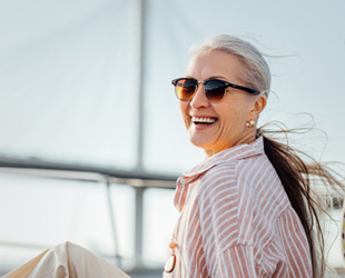 Older woman smiling while on a boat 