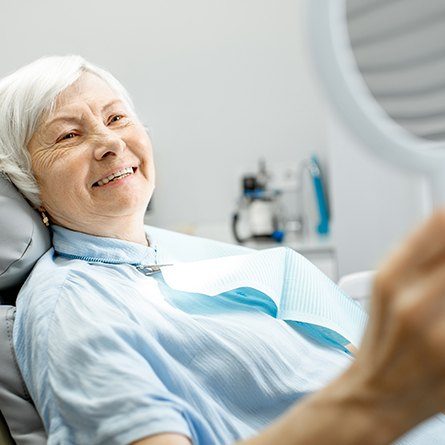 woman looking at smile in mirror