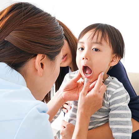 Dentist checking boys mouth