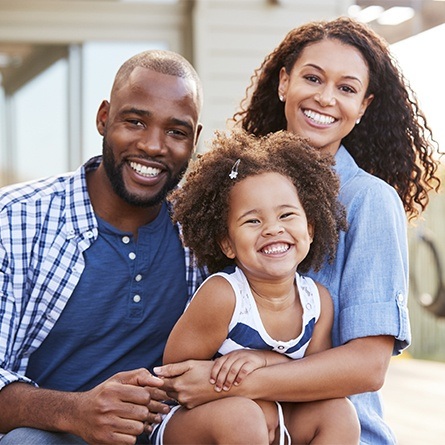 three family members smiling