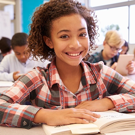 little girl in school smiling