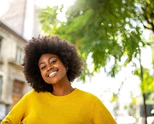 Woman smiling with veneers in Alamo Ranch  (Cost vs. Cosmetic Dentistry: What’s Right for Me? 