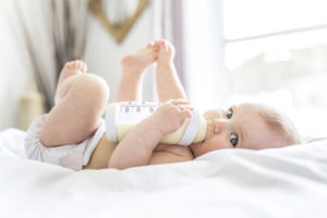 Baby laying down with a bottle