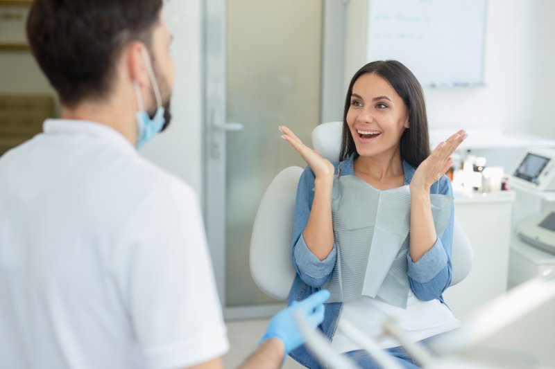 a woman smiling at her dentist