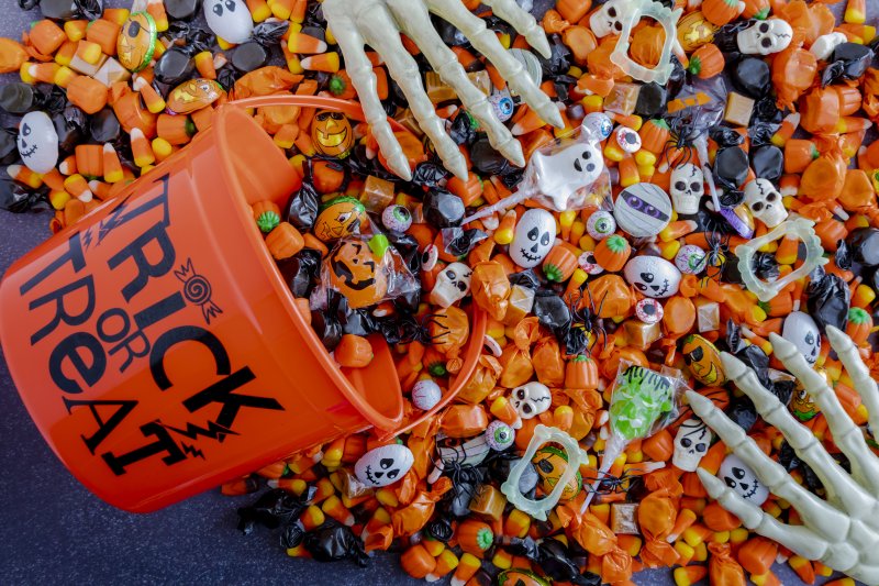 a Halloween bucket dumping out various candies and toys