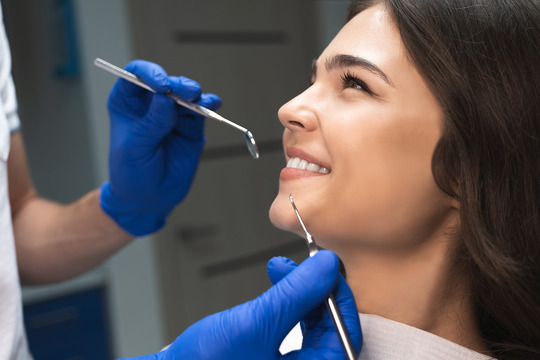 patient smiling while looking at dentist 