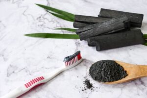 Activated charcoal next to toothbrush