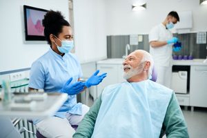 Dentist talking with patient during emergency visit 
